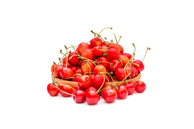 Wooden plate with cherries on white background