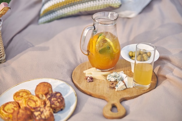 wooden plate with tasty meal for picnic in the outdoor