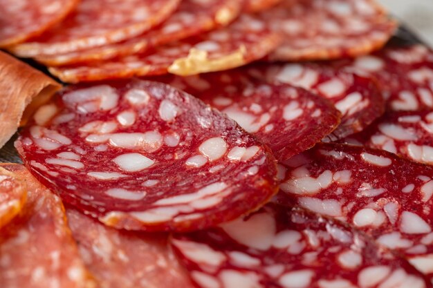 Wooden platter with meat cuts close up