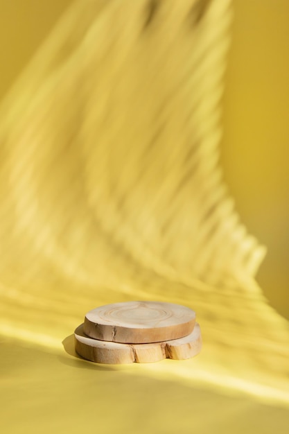 Wooden podium or pedestal in the shade of blinds for the presentation of cosmetics or perfumes