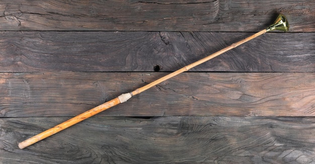 wooden pointer old wood cane isolated on wooden background