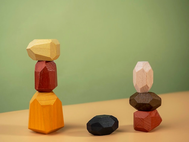 Wooden polyhedrons figures stacked on top of each other Balance figures