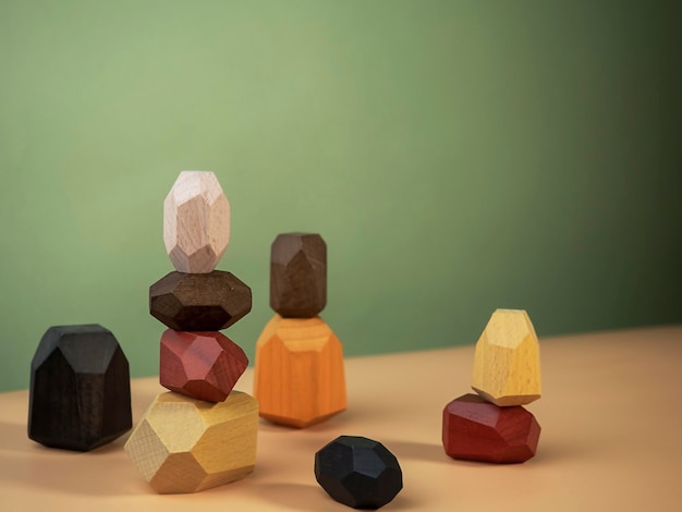 Wooden polyhedrons figures stacked on top of each other Balance figures