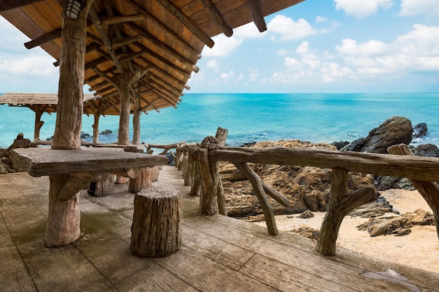 Wooden porch for view point at the beautiful beach on blue sky background