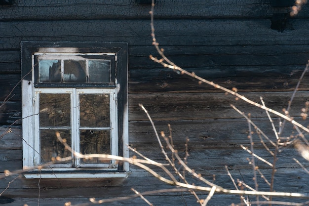 A wooden private house destroyed after a fire the consequences\
of a forest fire in the village charred walls of a timber house\
closeup