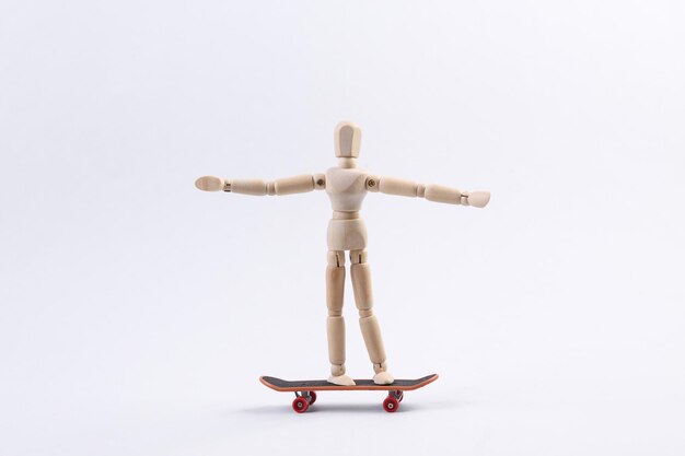 Wooden puppet is riding a skateboard