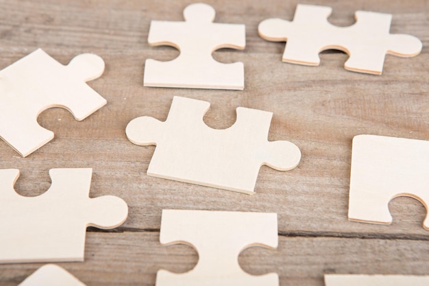 Wooden puzzle pieces on a wooden background