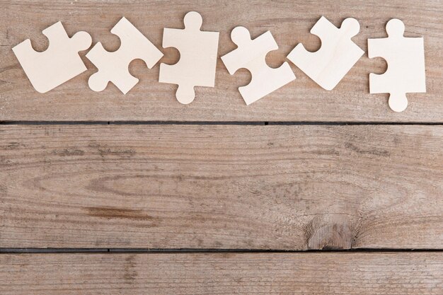 Wooden puzzle pieces on a wooden background