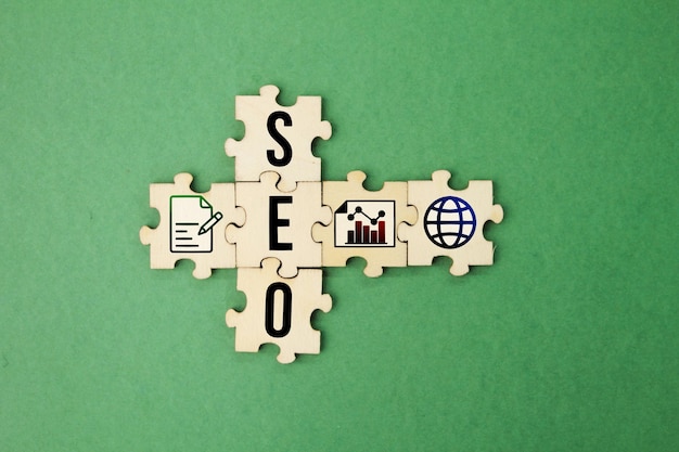 Photo wooden puzzle with the letter seo and its icon search engine optimization digital online marketing