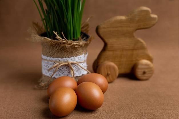 A wooden rabbit and eggs on a table