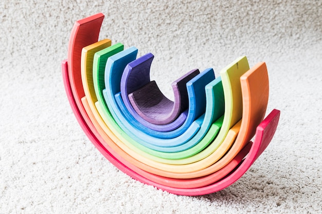 Wooden rainbow on white carpet