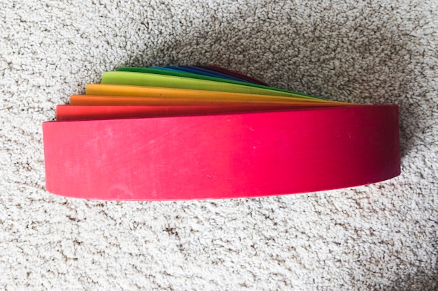 Wooden rainbow on white carpet