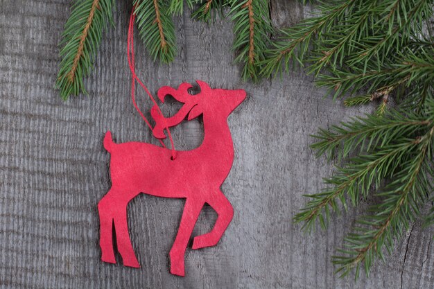 Wooden red christmas deer on wooden board.