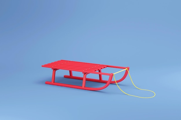 Photo wooden red sled on blue studio background