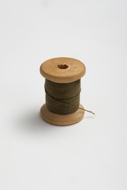 Wooden reels with thread on a solid background. tinting