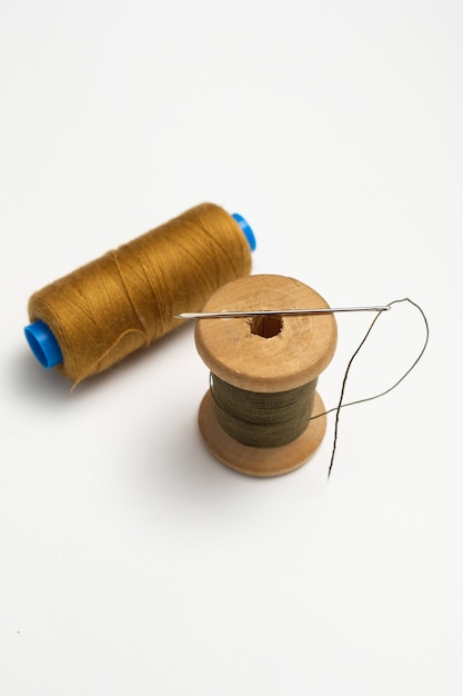 wooden reels with thread on a solid background. tinting