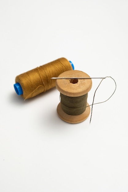 wooden reels with thread on a solid background. tinting