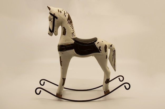 Wooden rocking horse toy on a light background