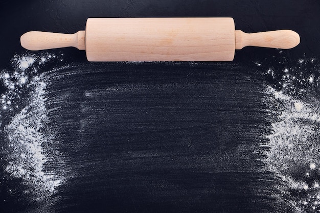 Wooden rolling pin and flour