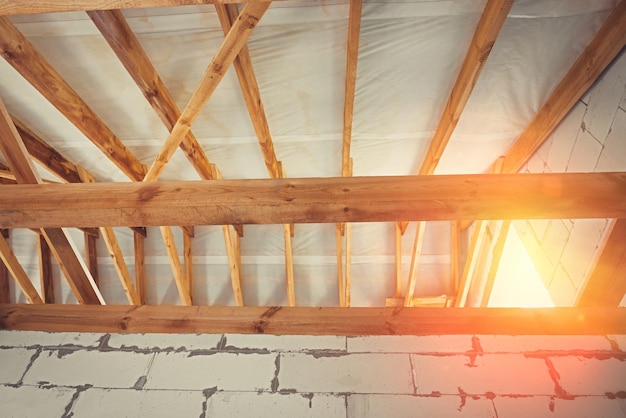 Wooden roof structures of a new residential building Construction of a residential building under