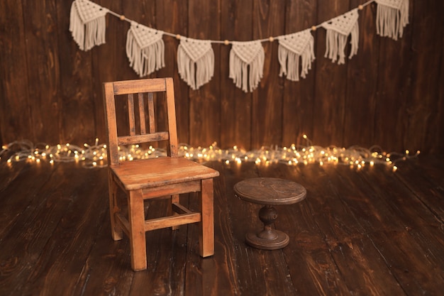Wooden room with birthday garlands with chair and cake stand