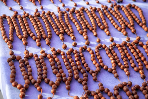 wooden rosaries on the table, mosque rosary. stress stones. brown stones strung on a thread.