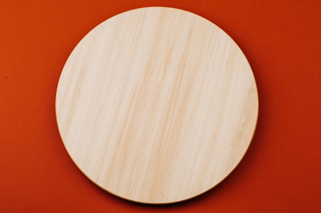 Wooden round board on the table