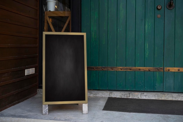 Wooden rustic blackboard in front of restaurant entrance