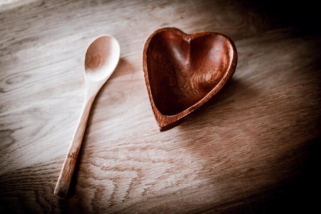 Wooden salad bowl in the shape of a heart and spoon