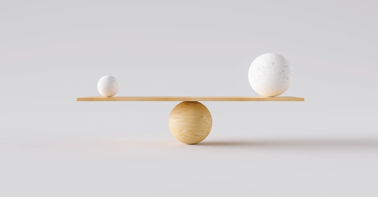 Photo wooden scale balancing one big ball and one small ball. concept of harmony and balance