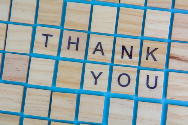 Photo wooden scrabble letters word thank you