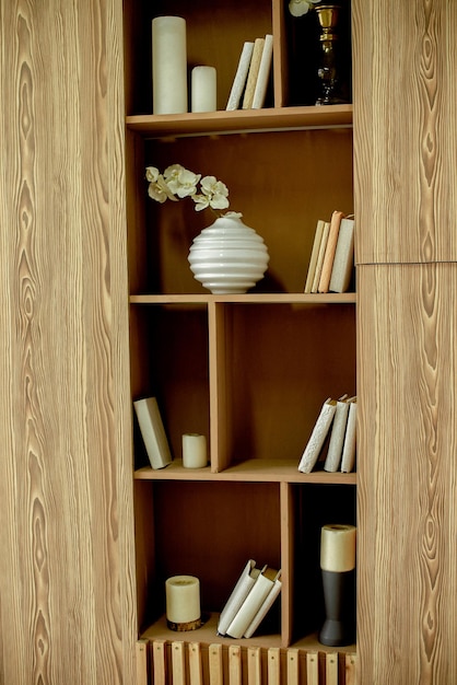 Wooden shelf with books and flower pot