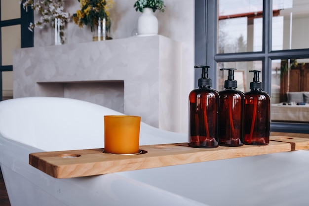 A wooden shelf with soaps and a candle on it