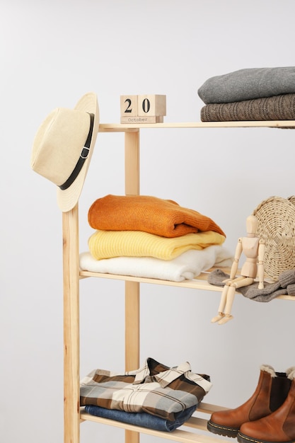 Wooden shelving with clothes autumn season clothes