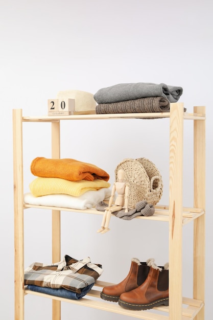 Wooden shelving with clothes autumn season clothes