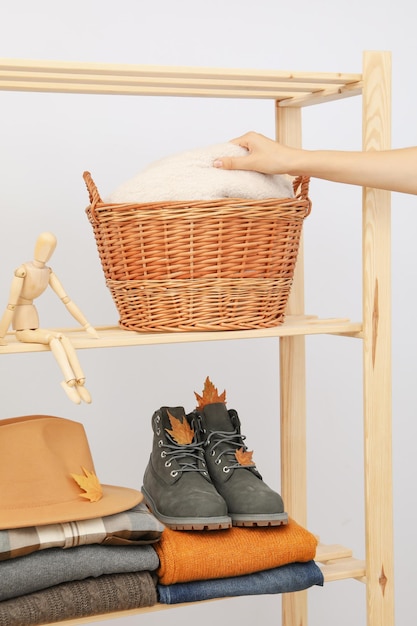 Wooden shelving with clothes autumn season clothes