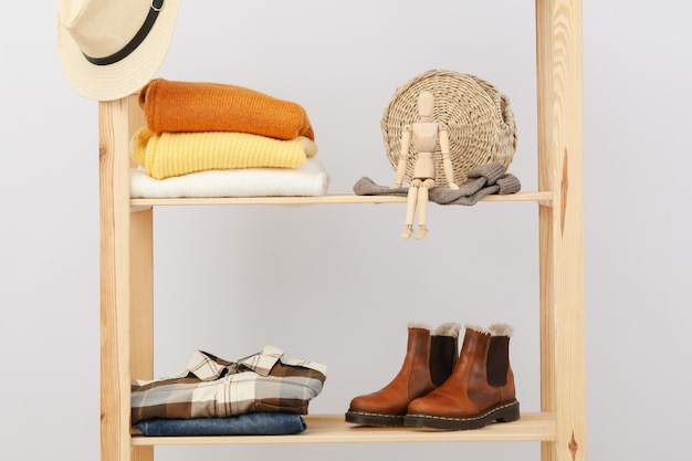 Photo wooden shelving with clothes autumn season clothes