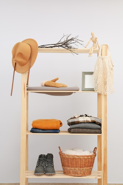 Wooden shelving with clothes concept of autumn season clothes