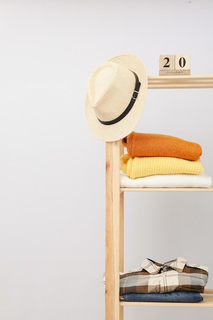 Wooden shelving with clothes concept of autumn season clothes