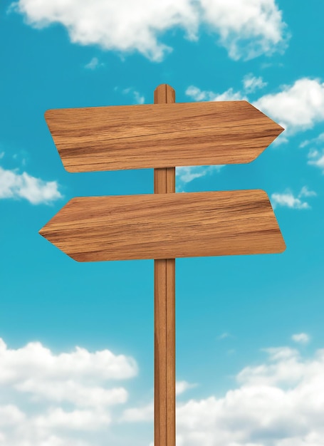 Wooden sign post isolated on blue sky with white clouds Direction concept Mock up template