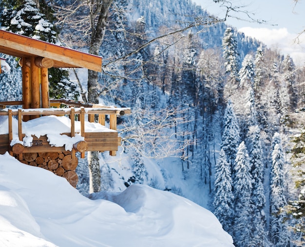 Wooden ski chalet in snow, mountain view