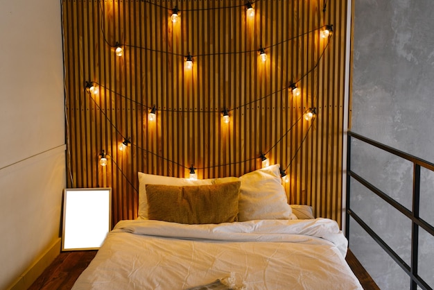 Photo wooden slats in the headboard of the bed in the scandinavian style retro light bulbs bedroom l