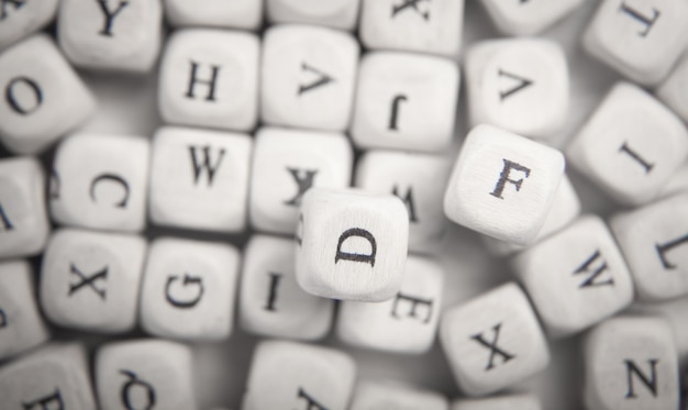 Wooden small cubes with letters.