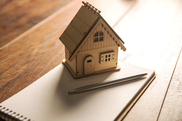 Wooden small house and notebook