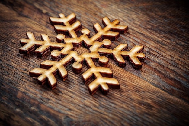 Wooden snowflake on wooden plank