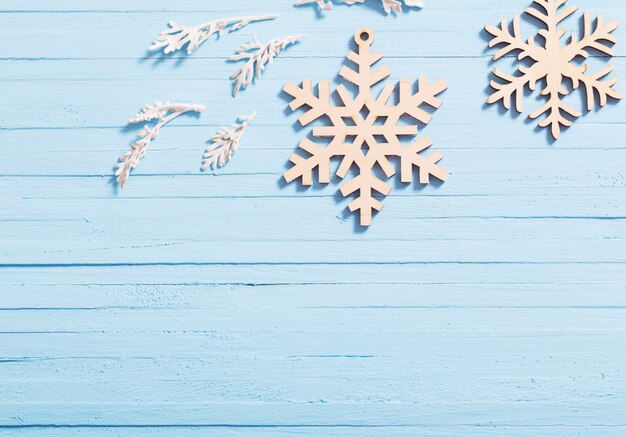 Wooden snowflakes on blue background