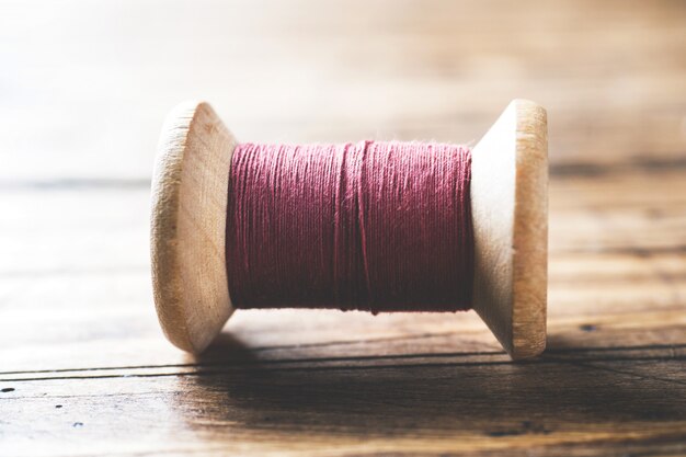 Wooden spools of thread close-up.