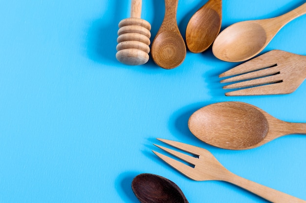 Wooden spoon on blue background, for background menu food