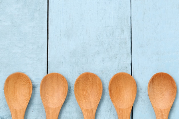 Wooden spoon on blue wood floors.