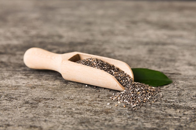 Wooden spoon and chia seeds on colored background top view Healthy Salvia hispanica Healthy superfood